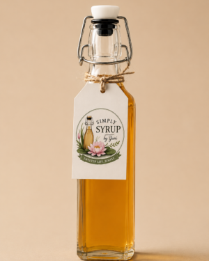 Handcrafted vanilla bean simple syrup in a reusable glass bottle on a warm beige background.