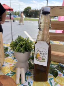 pumkin spice simple syrup bottle on table with lemon pattern cloth