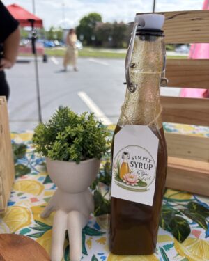 pumkin spice simple syrup bottle on table with lemon pattern cloth